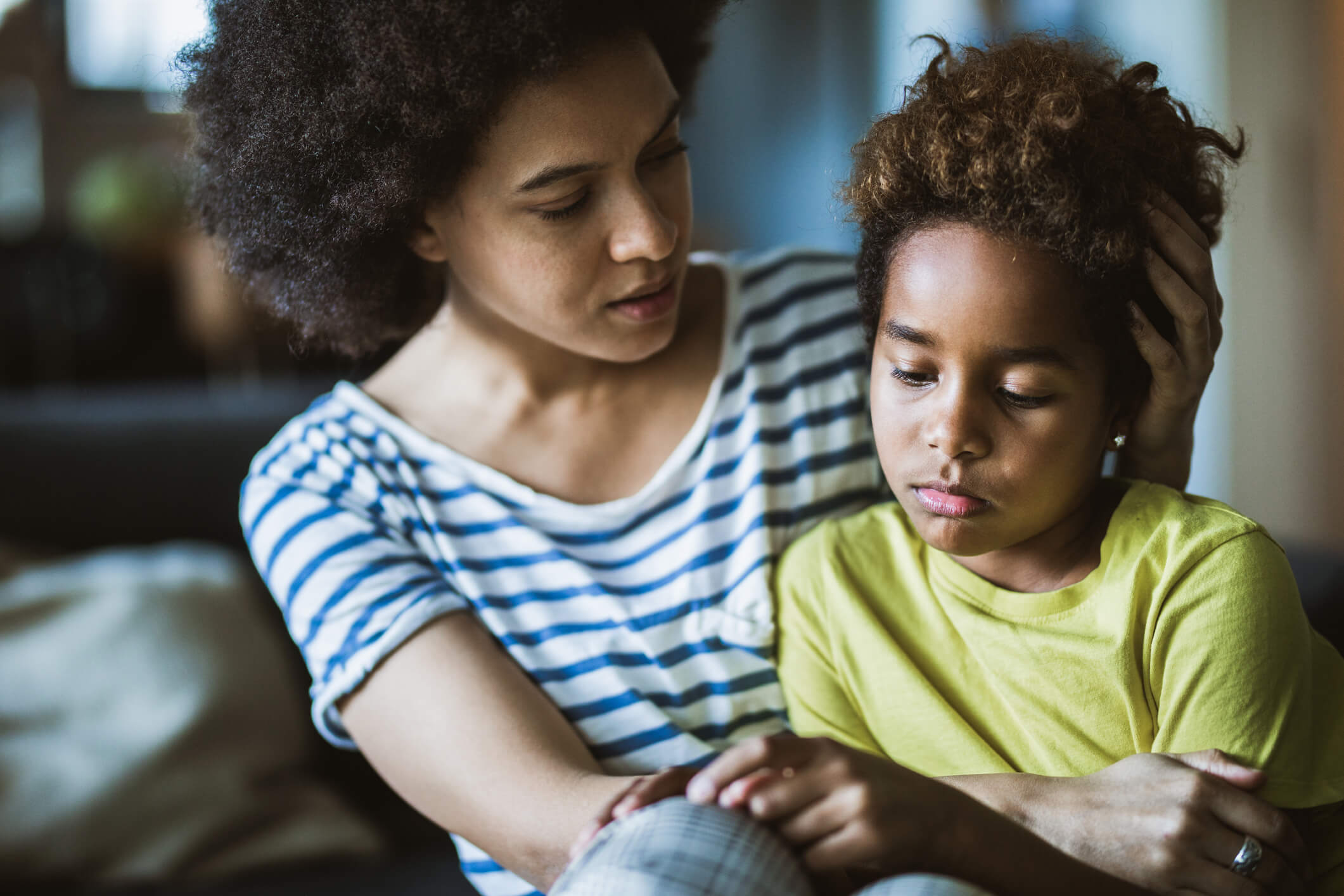 mother comforting sad child